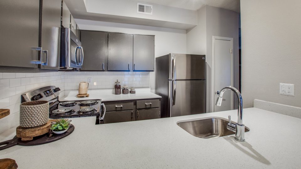 a kitchen with stainless steel appliances and a sink at The Felix