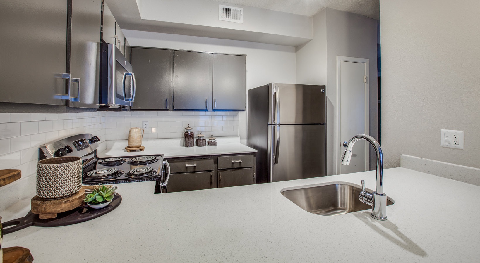 a kitchen with stainless steel appliances and a sink at The Felix